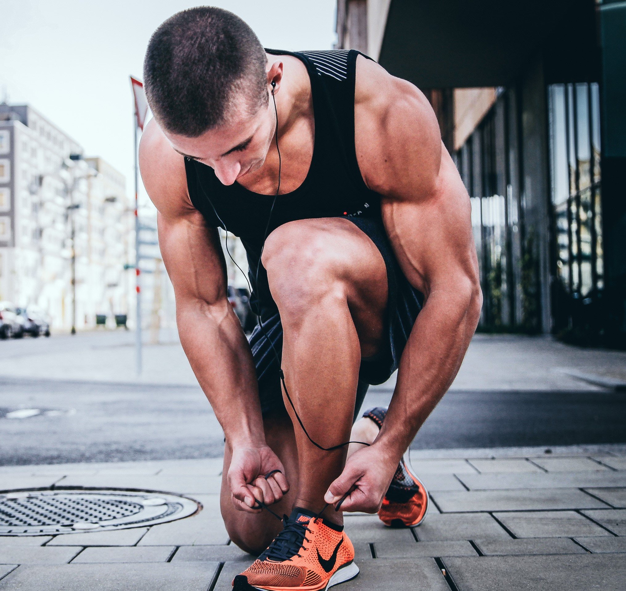 Athletic man tying his shoes